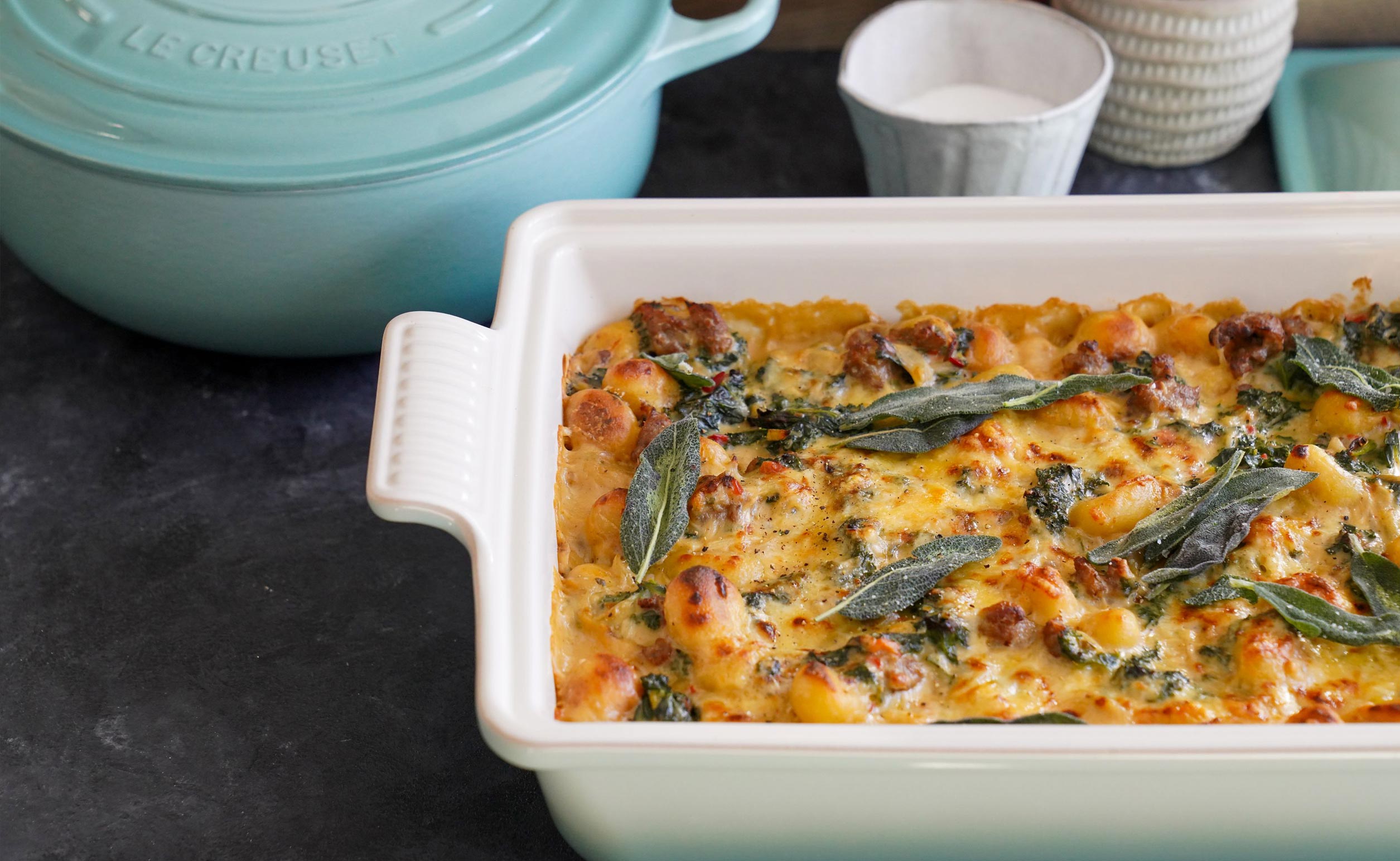 Baked gnocchi with a Le Creuset pot in the background