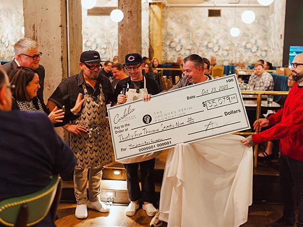 Chefs Michael Symon and Vinnie Cimino presenting a check to the JPF